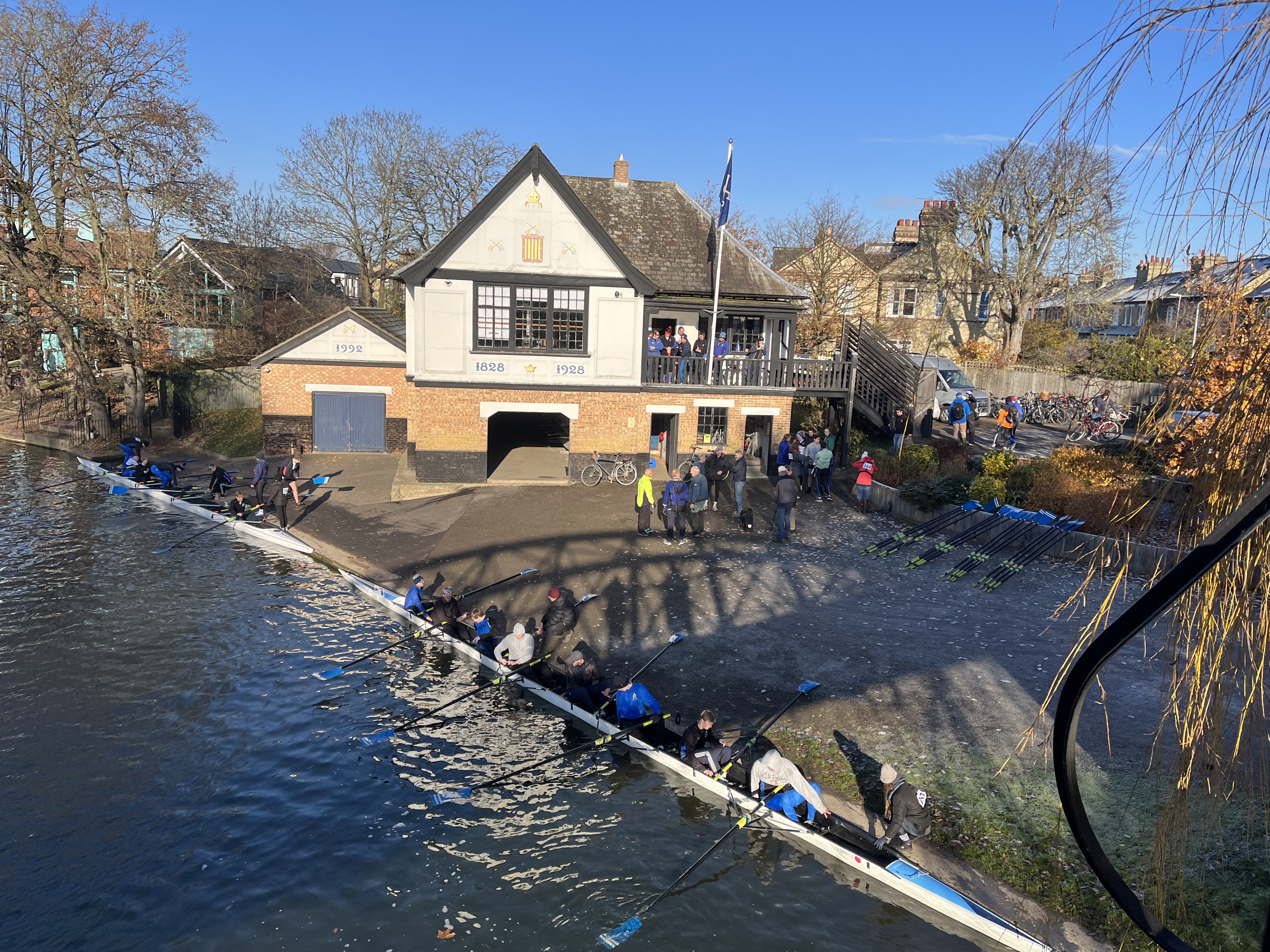 Student crews return to the boathouse post-race while alumni gather in preparation for their races